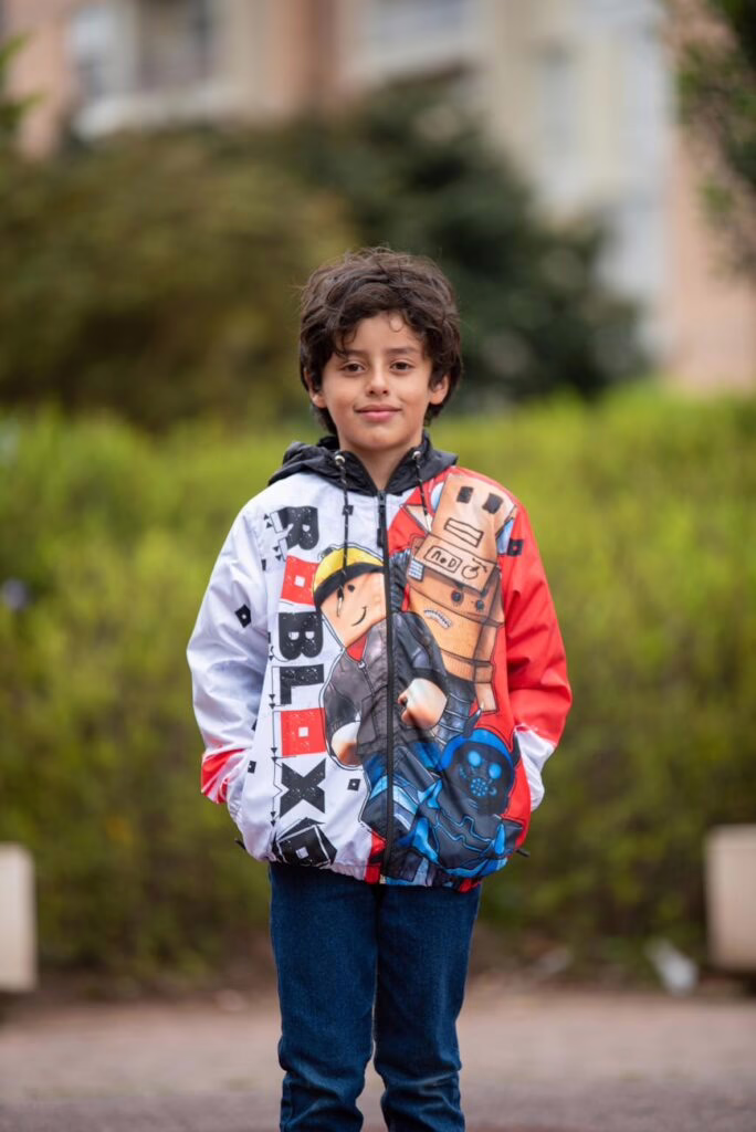 a boy wearing an animated hoodie sweater