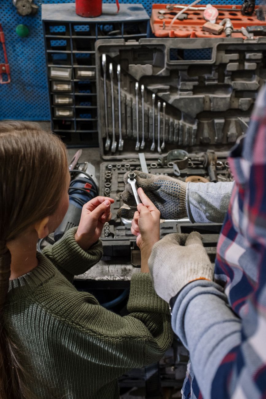 woman in green jacket holding smartphone